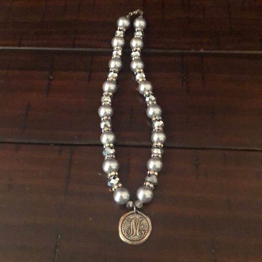 Silver necklace with a M.